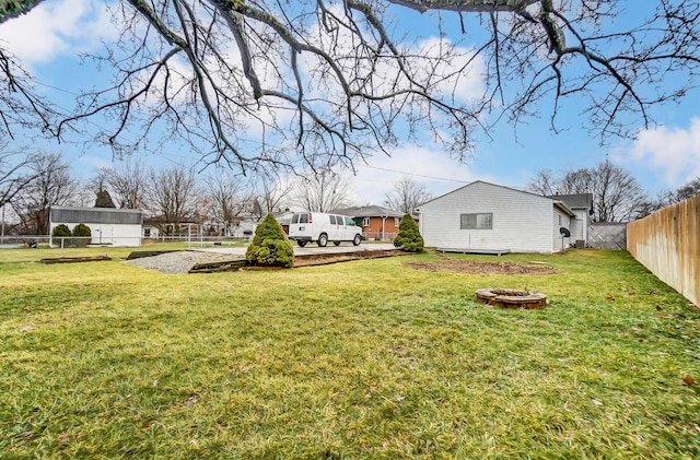 view of yard with a fire pit