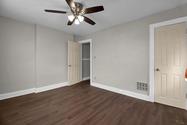 interior space with dark wood-type flooring and ceiling fan