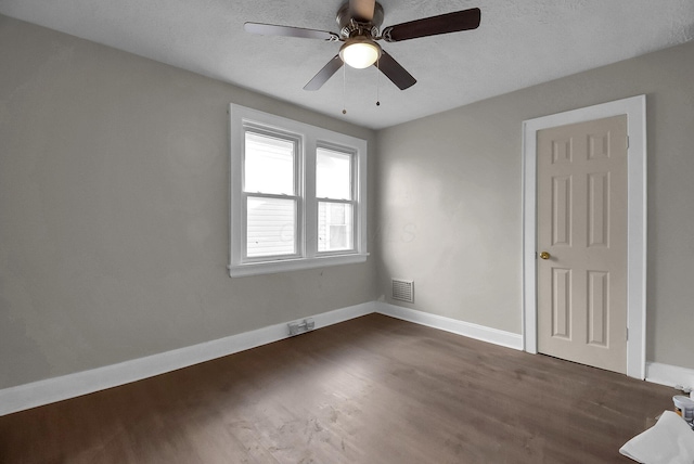 empty room featuring dark wood-type flooring and ceiling fan