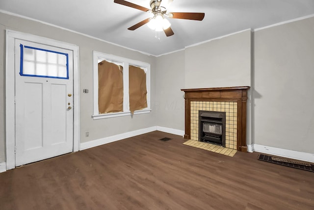 unfurnished living room featuring dark hardwood / wood-style flooring, ornamental molding, and ceiling fan