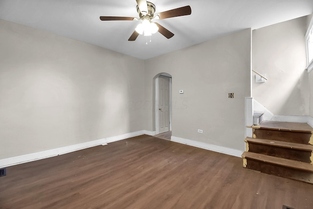 unfurnished room featuring dark wood-type flooring and ceiling fan