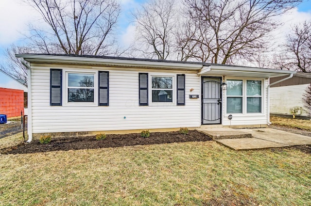 view of front of house with a patio area and a front lawn