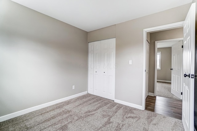 unfurnished bedroom featuring carpet floors and a closet