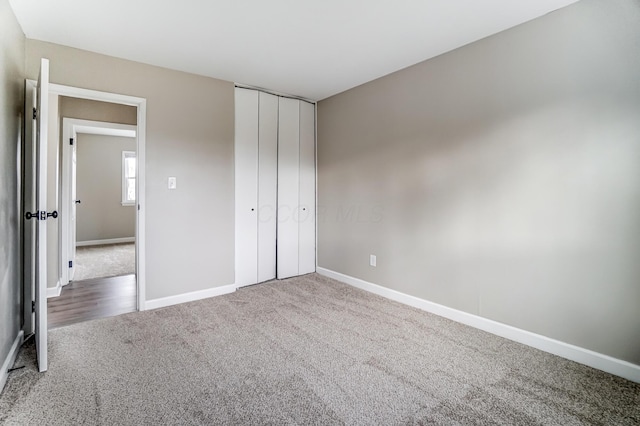 unfurnished bedroom with carpet flooring and a closet