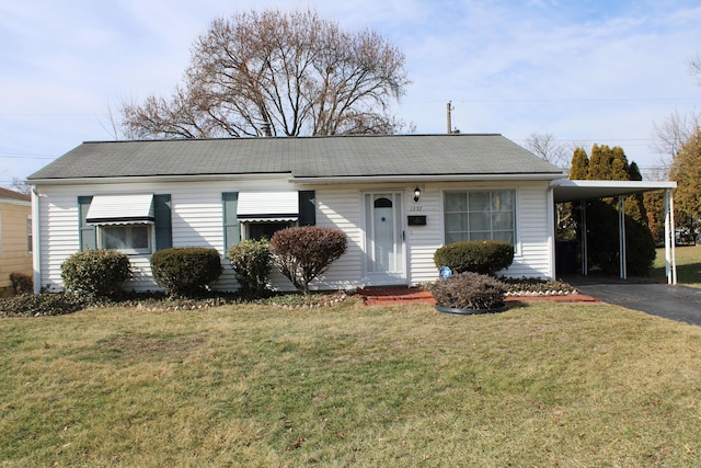 ranch-style house featuring a carport, a front yard, and driveway