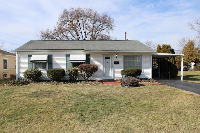 single story home featuring driveway, an attached carport, and a front lawn