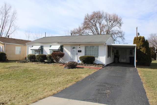 ranch-style house with a carport, aphalt driveway, and a front lawn