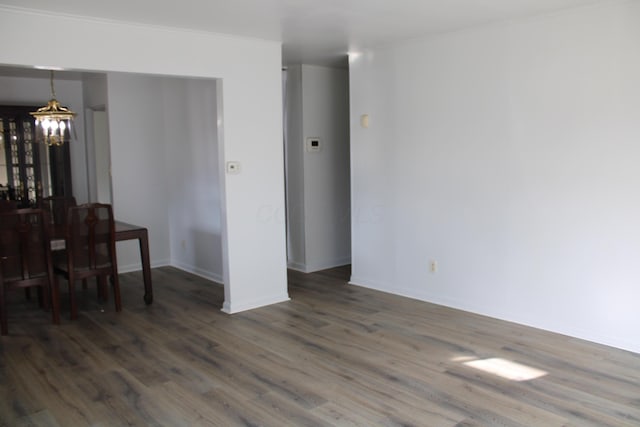 dining area with a chandelier, baseboards, and wood finished floors