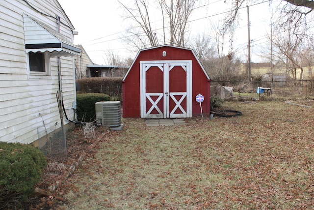 view of shed featuring fence and cooling unit