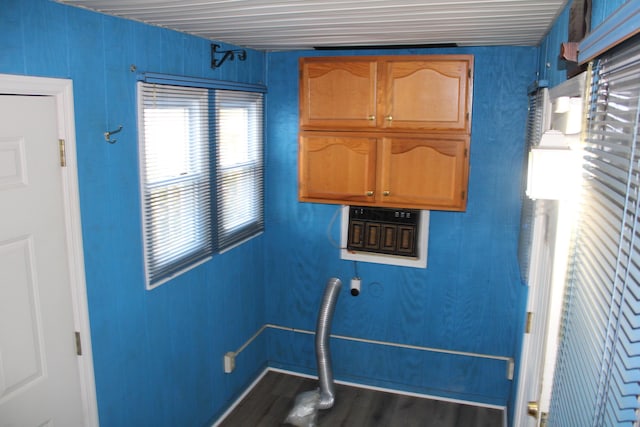 laundry room with dark wood-style flooring and cabinet space