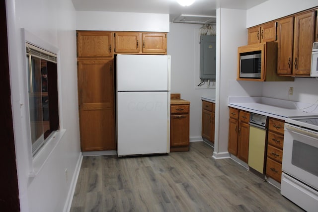 kitchen with brown cabinetry, white appliances, electric panel, and light wood-style floors