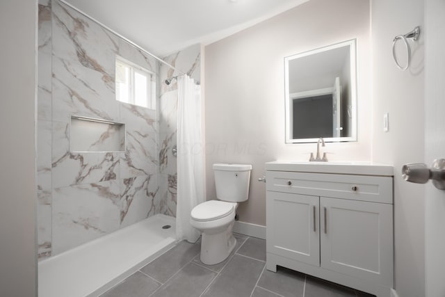 bathroom with vanity, curtained shower, tile patterned floors, and toilet