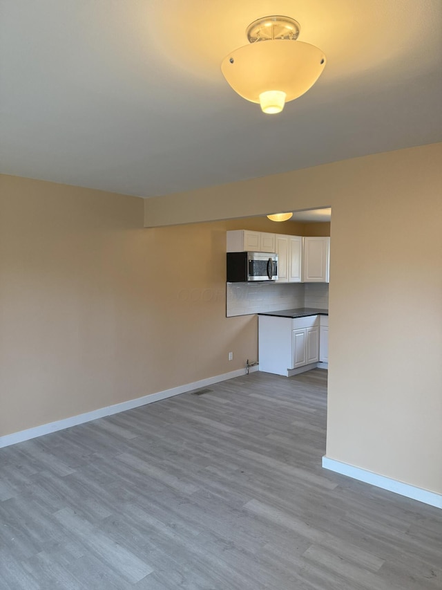 unfurnished living room with light hardwood / wood-style flooring