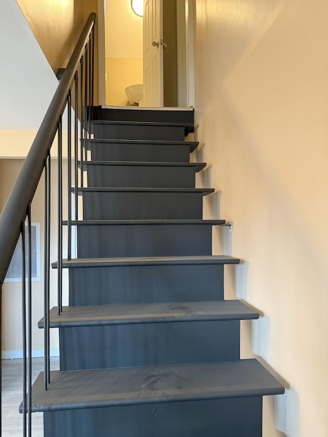 stairs with hardwood / wood-style flooring