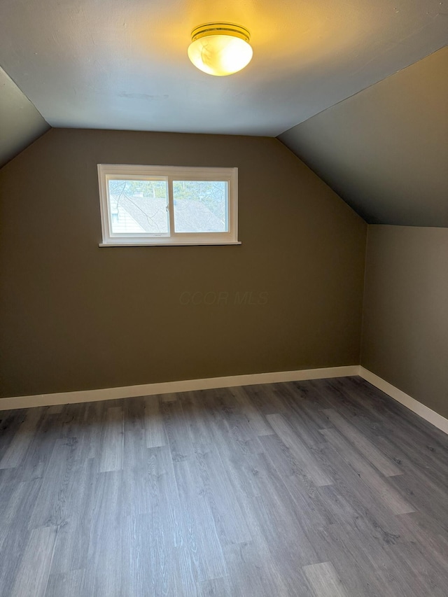 bonus room with vaulted ceiling and hardwood / wood-style floors