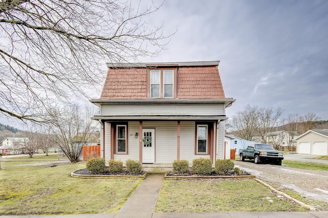 view of front of property with a porch and a front yard