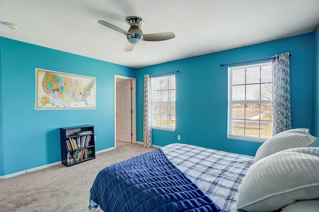 carpeted bedroom with multiple windows and ceiling fan