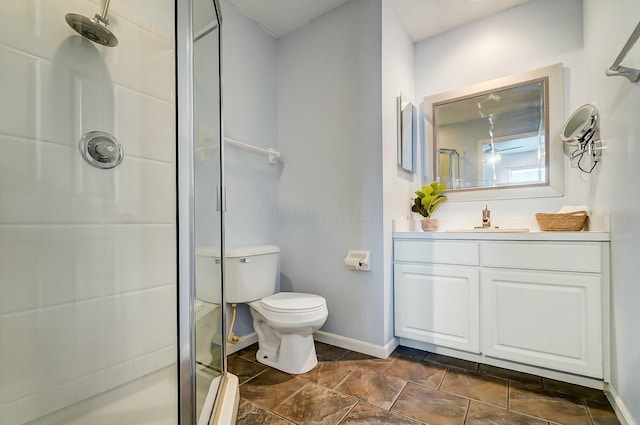 bathroom featuring vanity, toilet, and a shower with shower door