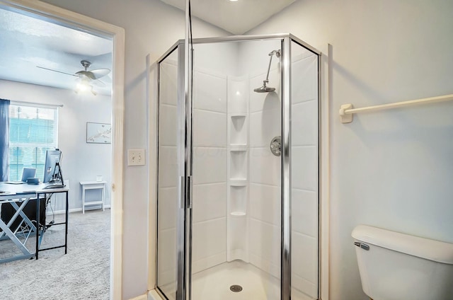 bathroom featuring toilet, ceiling fan, and a shower with shower door