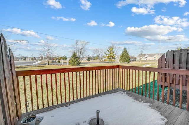 wooden deck featuring a lawn