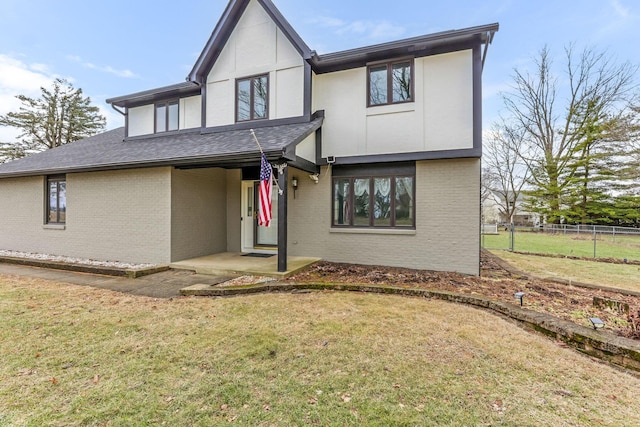 tudor-style house with a front yard