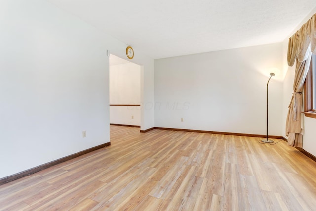 unfurnished room with light hardwood / wood-style floors