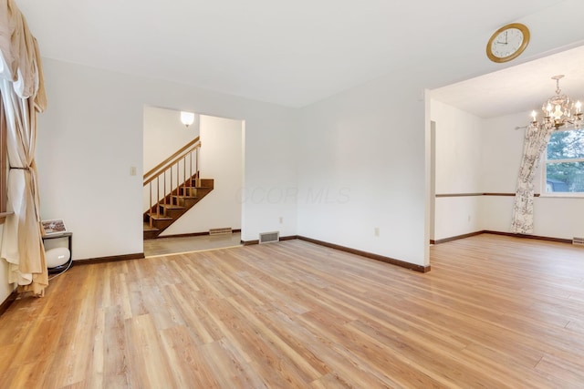 interior space with light hardwood / wood-style floors and a notable chandelier