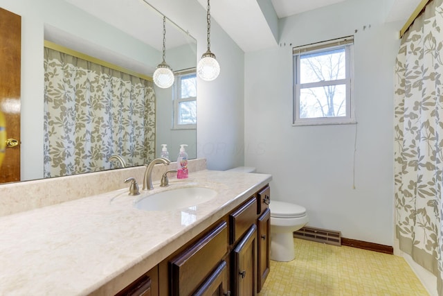 bathroom with vanity, a wealth of natural light, and toilet