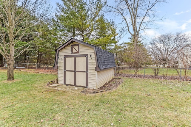 view of outbuilding with a yard