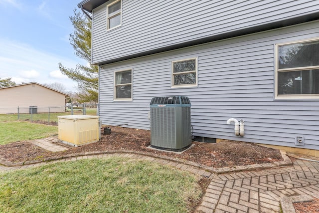 view of property exterior featuring a lawn and central air condition unit