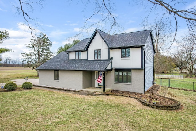 tudor house featuring a front yard