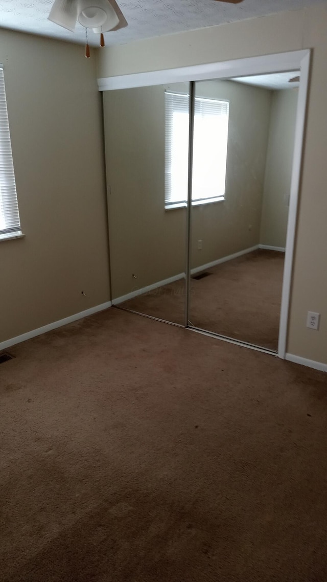 unfurnished bedroom featuring a closet and carpet