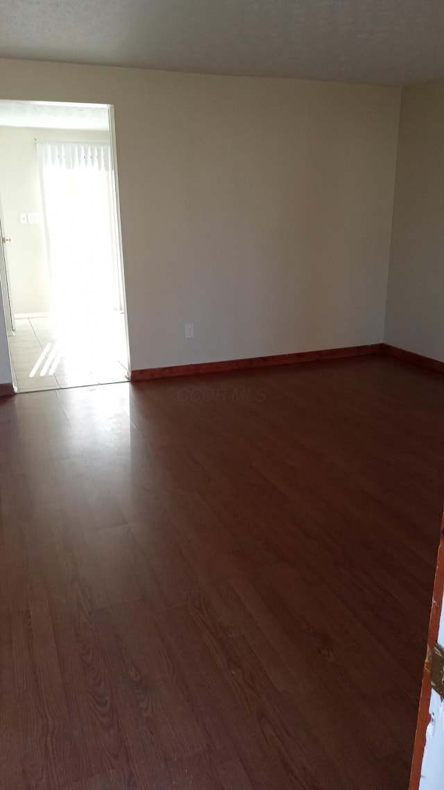 spare room featuring dark hardwood / wood-style floors