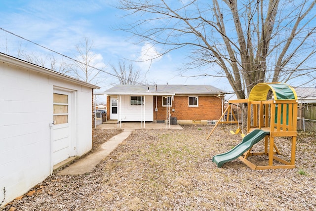 back of house featuring a playground