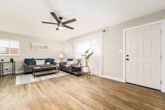 living room featuring ceiling fan and wood-type flooring