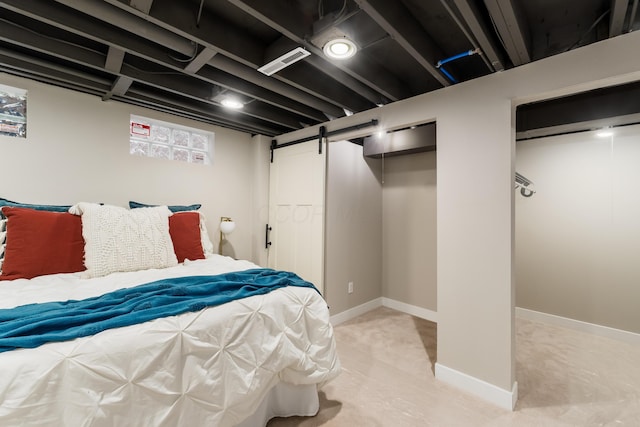 bedroom with two closets and a barn door