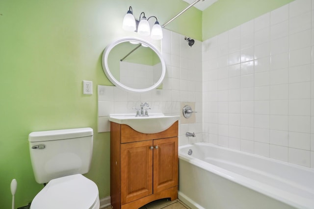 full bathroom with tiled shower / bath, vanity, and toilet