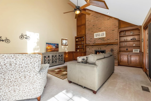 living room featuring high vaulted ceiling, light carpet, built in features, and a fireplace