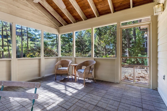 unfurnished sunroom with wood ceiling, lofted ceiling, and plenty of natural light