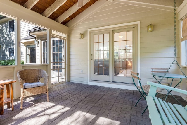 sunroom / solarium featuring lofted ceiling and wooden ceiling