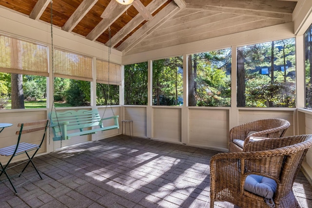 unfurnished sunroom featuring ceiling fan and lofted ceiling