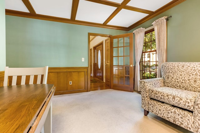 living area with crown molding and light colored carpet