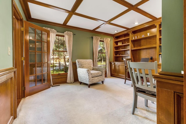 carpeted home office with built in shelves, coffered ceiling, and crown molding