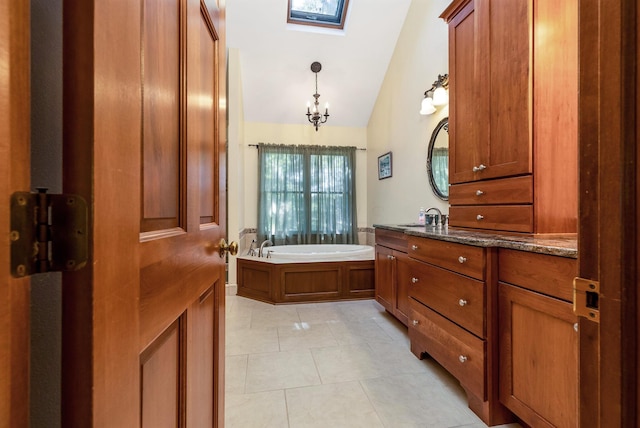 bathroom with vanity, tile patterned flooring, vaulted ceiling, and a washtub