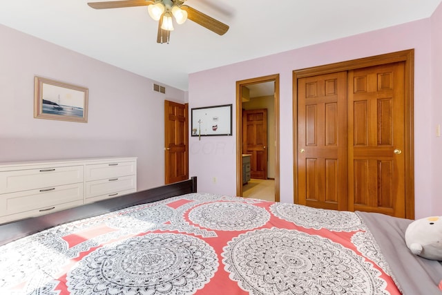 bedroom with ensuite bathroom, ceiling fan, and a closet