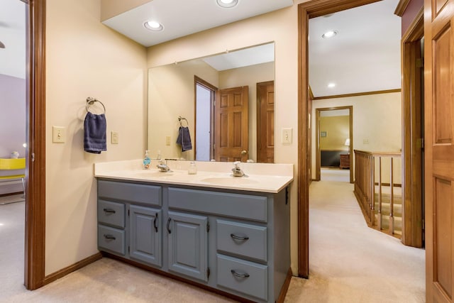 bathroom with ornamental molding and vanity