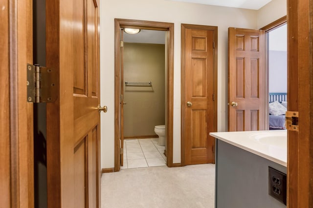 bathroom with vanity, tile patterned floors, and toilet