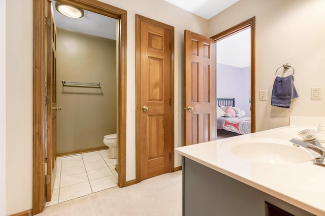 bathroom with vanity, toilet, and tile patterned flooring