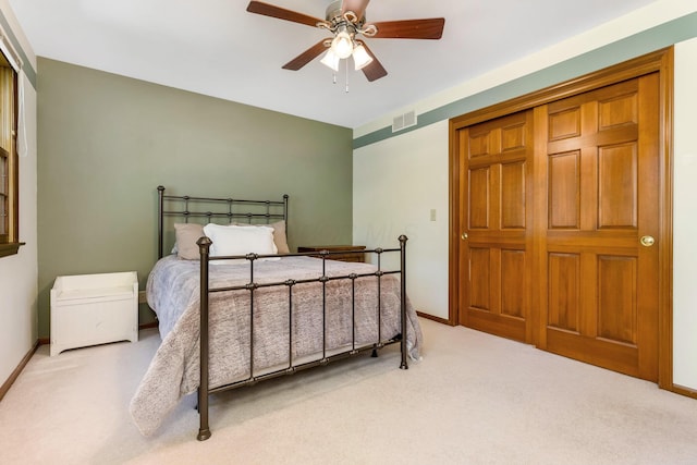 bedroom featuring light colored carpet and ceiling fan