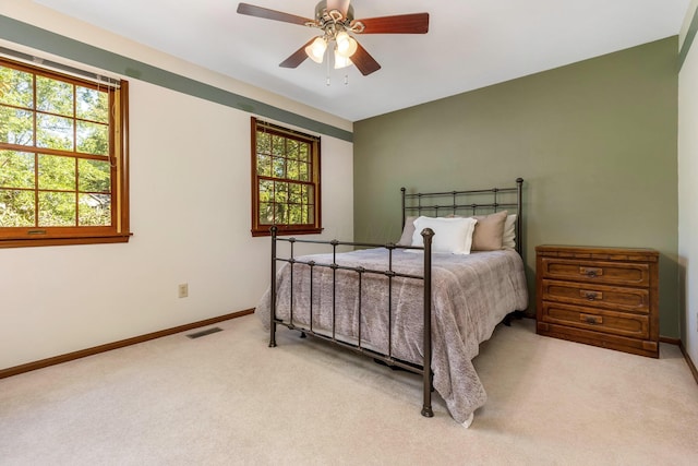 bedroom with ceiling fan and light colored carpet